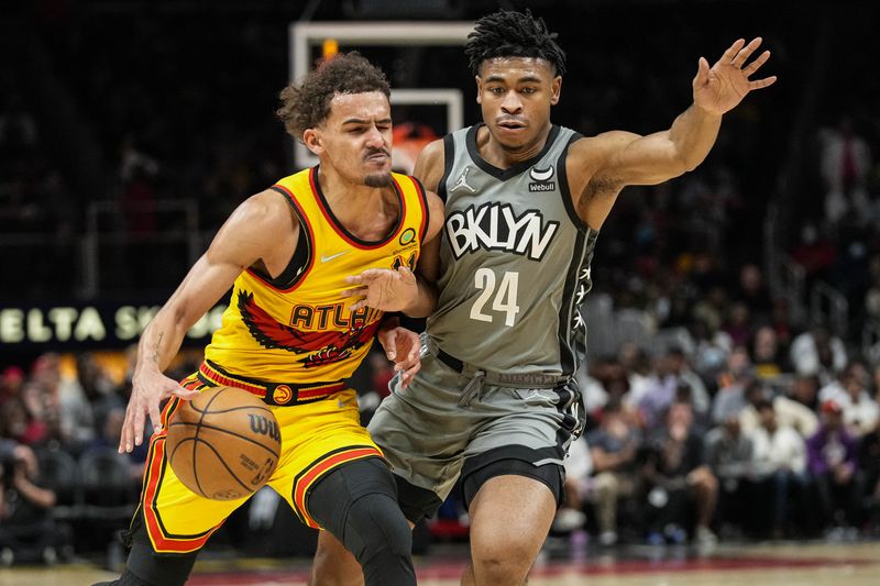 Apr 2, 2022; Atlanta, Georgia, USA; Atlanta Hawks guard Trae Young (11) is guarded by Brooklyn Nets guard Cam Thomas (24) during the second half at State Farm Arena. / Dale Zanine-USA TODAY Sports