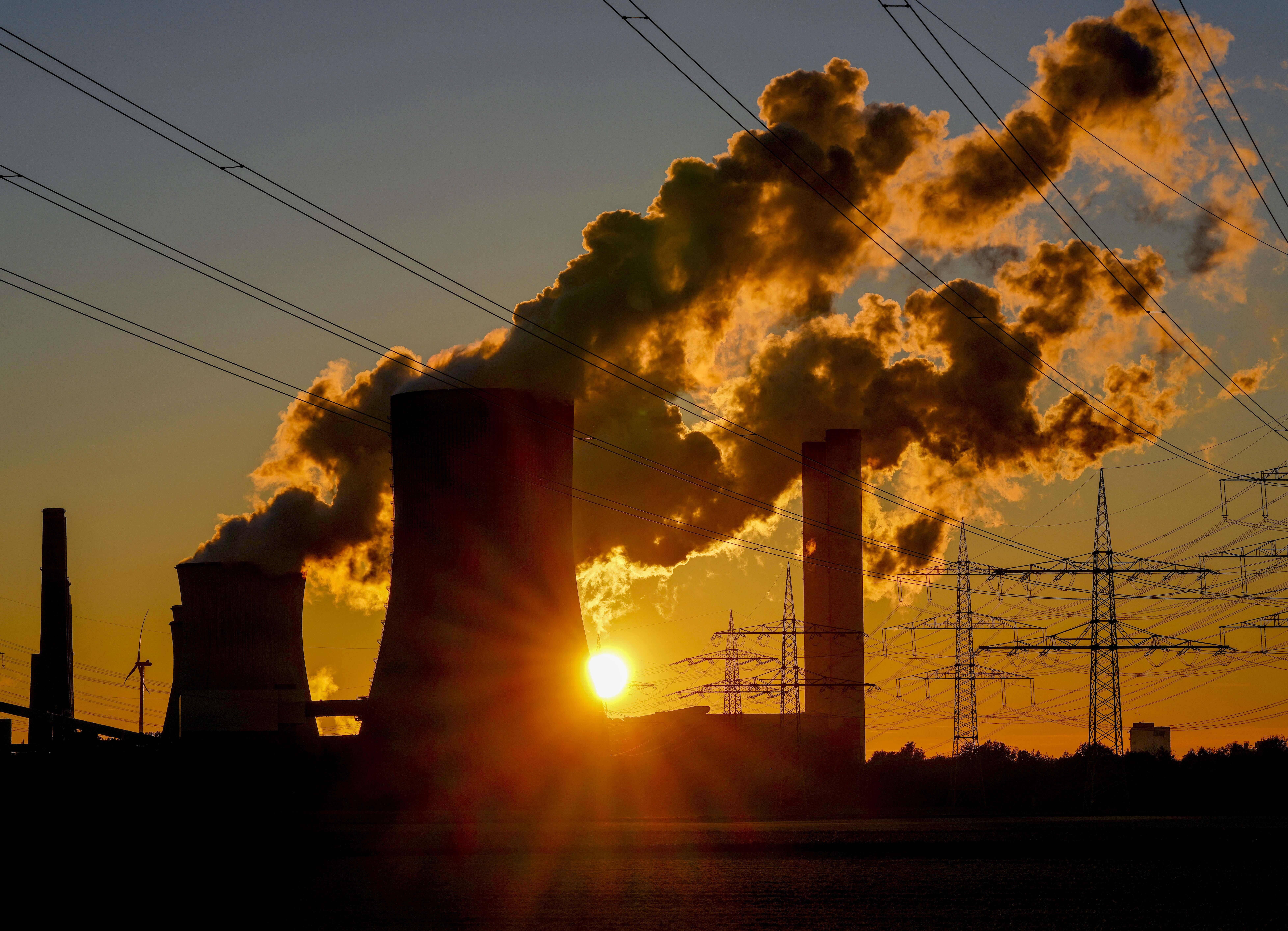 Steam comes out of the chimneys of the coal-fired power station in Niederaussem, Germany, Oct. 24, 2021. Negotiations between scientists and governments over a key United Nations climate report were going down to the wire Sunday. 
