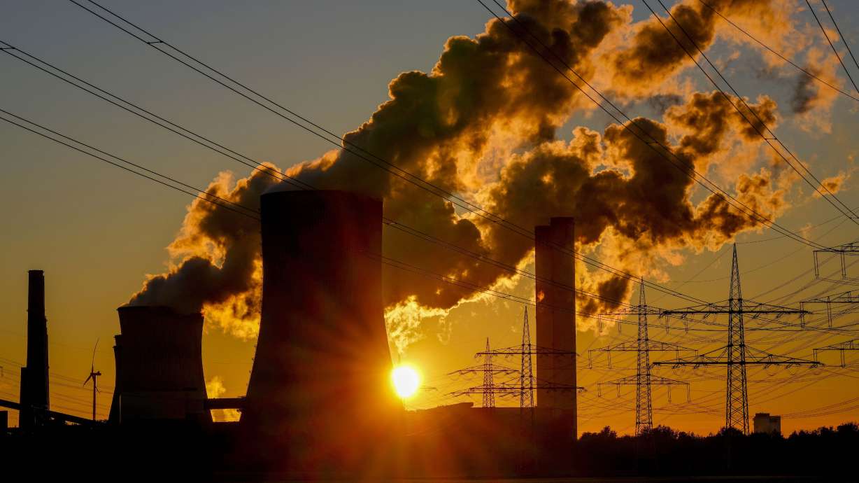Steam comes out of the chimneys of the coal-fired power station in Niederaussem, Germany, Oct. 24, 2021. Negotiations between scientists and governments over a key United Nations climate report were going down to the wire Sunday.