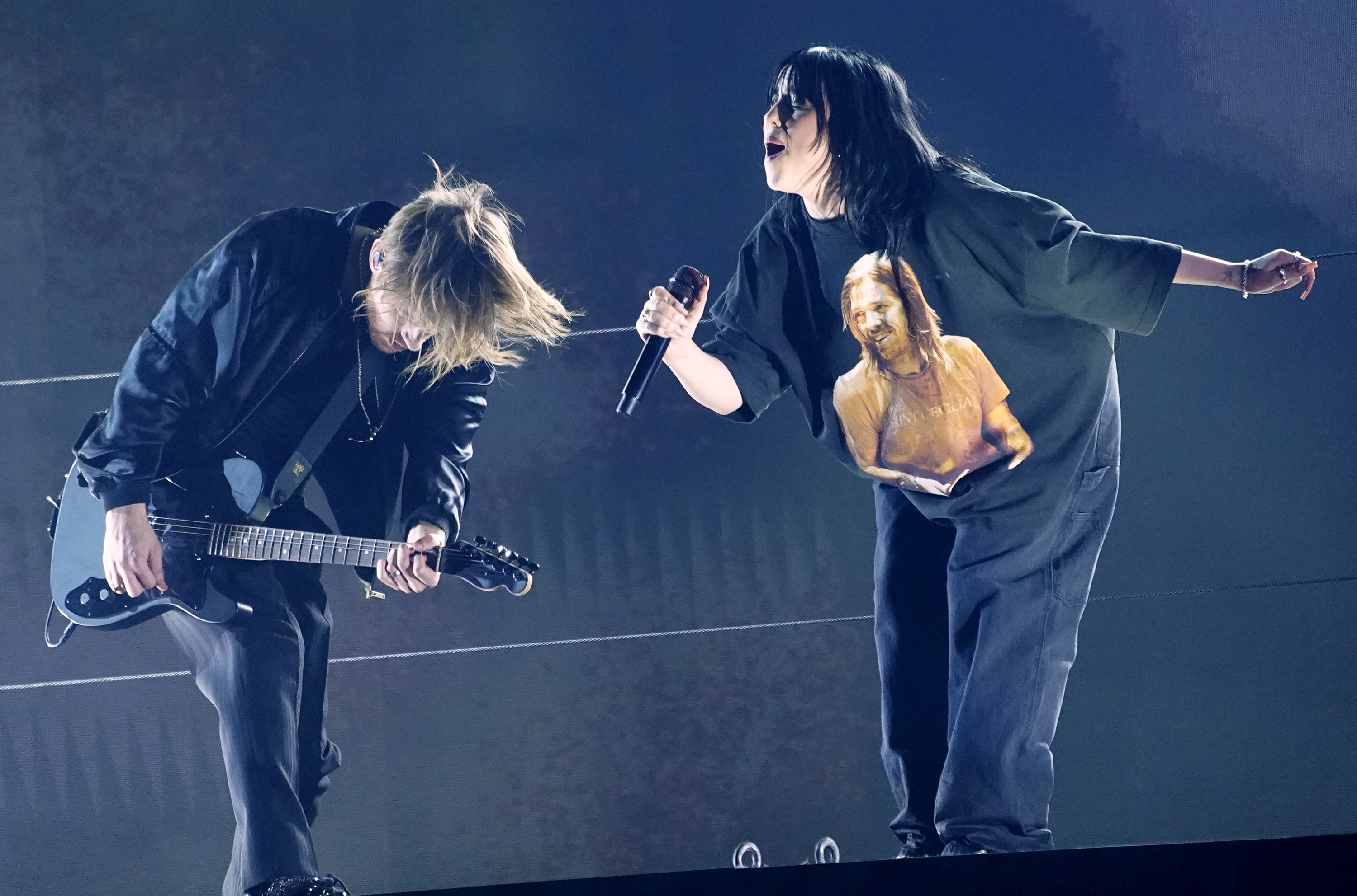 The late Taylor Hawkins appears on the shirt of Billie Eilish, right, as she and FINNEAS perform "Happier Than Ever" at the 64th Annual Grammy Awards on Sunday, in Las Vegas.