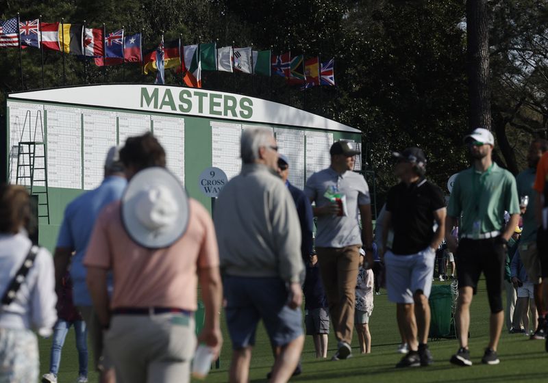 Golf - The Masters - Augusta National Golf Club - Augusta, Georgia, U.S. - April 4, 2022 General view of patrons and the scoreboard