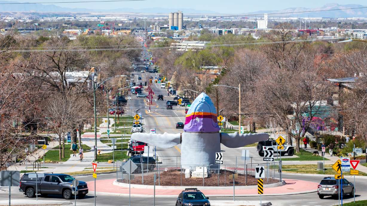 Vehicles drive around "Out of the Blue," a full-size sculpture of a humpback whale in Salt Lake City's 9th and 9th neighborhood, Sunday morning. The sculpture was installed over the weekend.