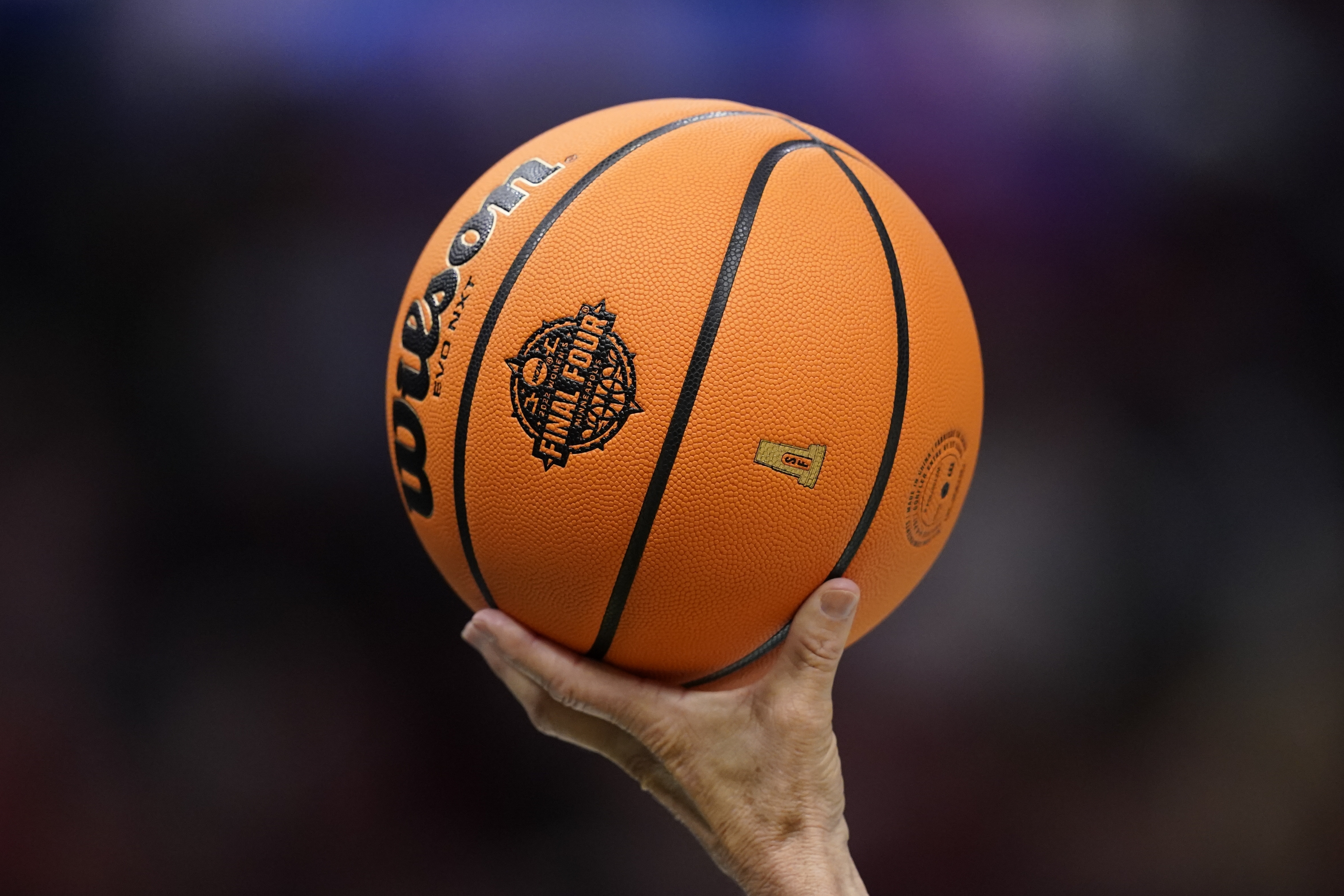 A referee holds up a ball during the second half of a college basketball game in the semifinal round of the Women's Final Four NCAA tournament between South Carolina and Louisville Friday, April 1, 2022, in Minneapolis. 