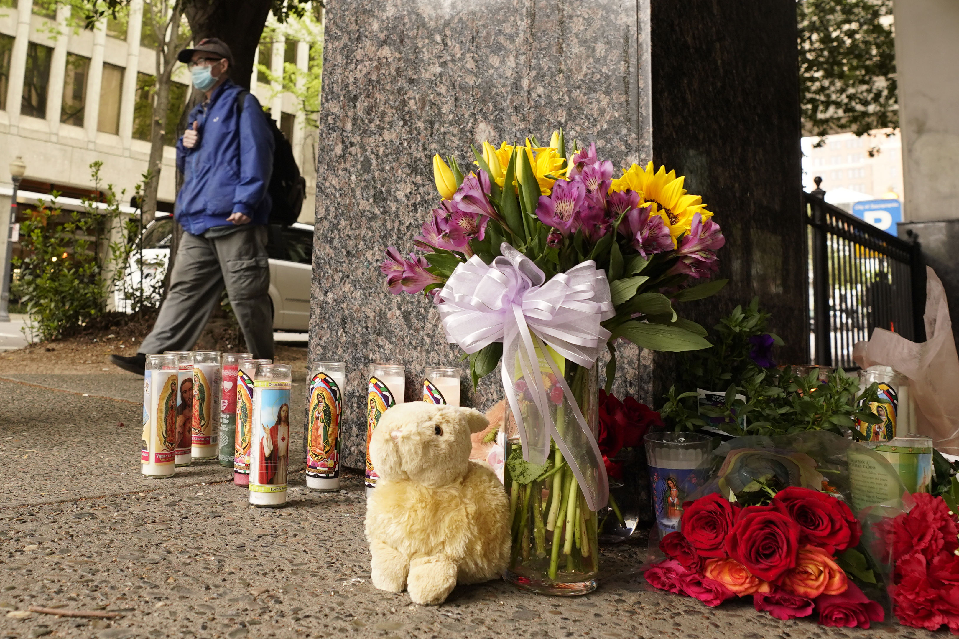 A person passes a memorial near the location of a mass shooting in Sacramento, Calif., Monday. Multiple people were killed and injured in the shooting a day earlier.