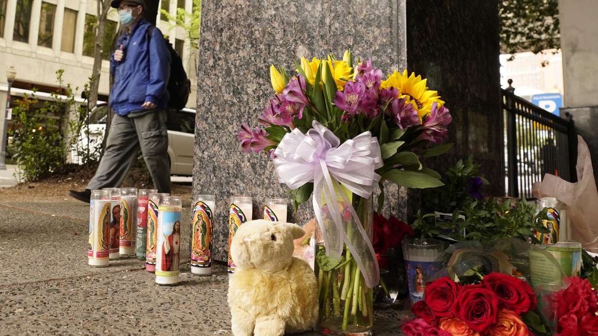 A person passes a memorial near the location of a mass shooting in Sacramento, Calif., Monday. Multiple people were killed and injured in the shooting a day earlier.