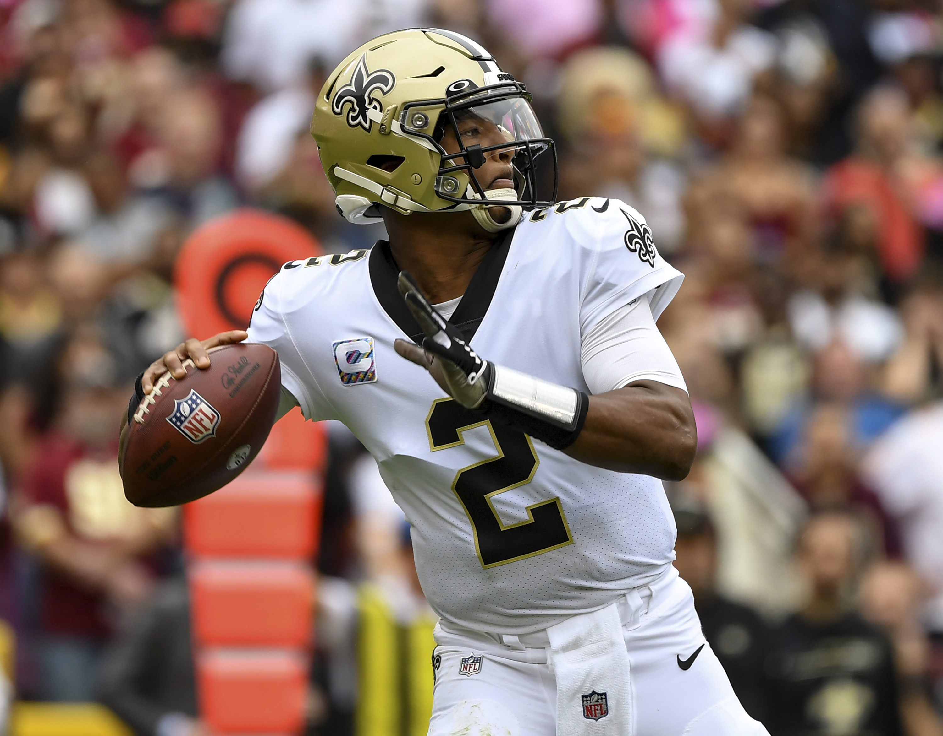 FILE - New Orleans Saints quarterback Jameis Winston prepares to pass the ball during the first half of an NFL football game against the Washington Football Team, Oct. 10, 2021, in Landover, Md. A person familiar with the situation says free agent Winston has agreed to return to the Saints. The person spoke to The Associated Press on condition of anonymity on Monday, March 21, 2022, because the agreement has not been announced. 