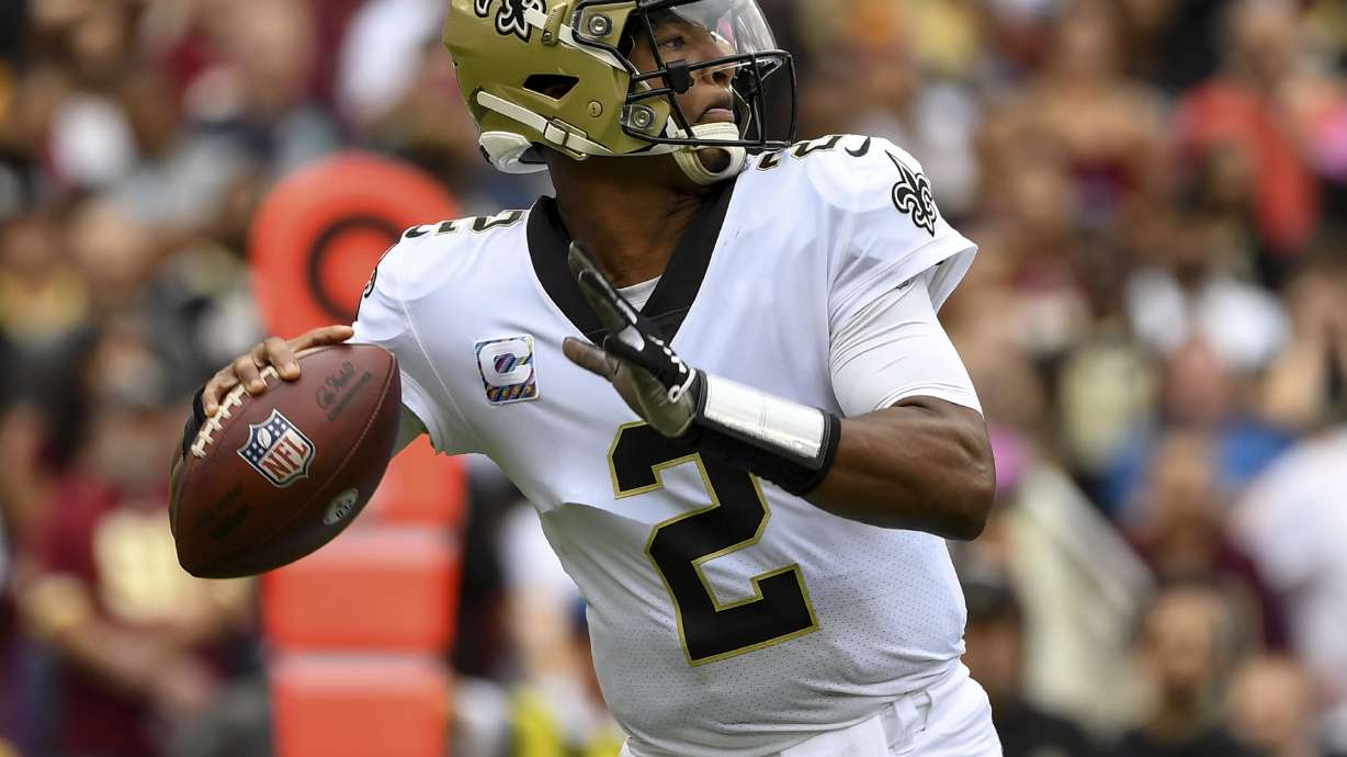 FILE - New Orleans Saints quarterback Jameis Winston prepares to pass the ball during the first half of an NFL football game against the Washington Football Team, Oct. 10, 2021, in Landover, Md. A person familiar with the situation says free agent Winston has agreed to return to the Saints. The person spoke to The Associated Press on condition of anonymity on Monday, March 21, 2022, because the agreement has not been announced.