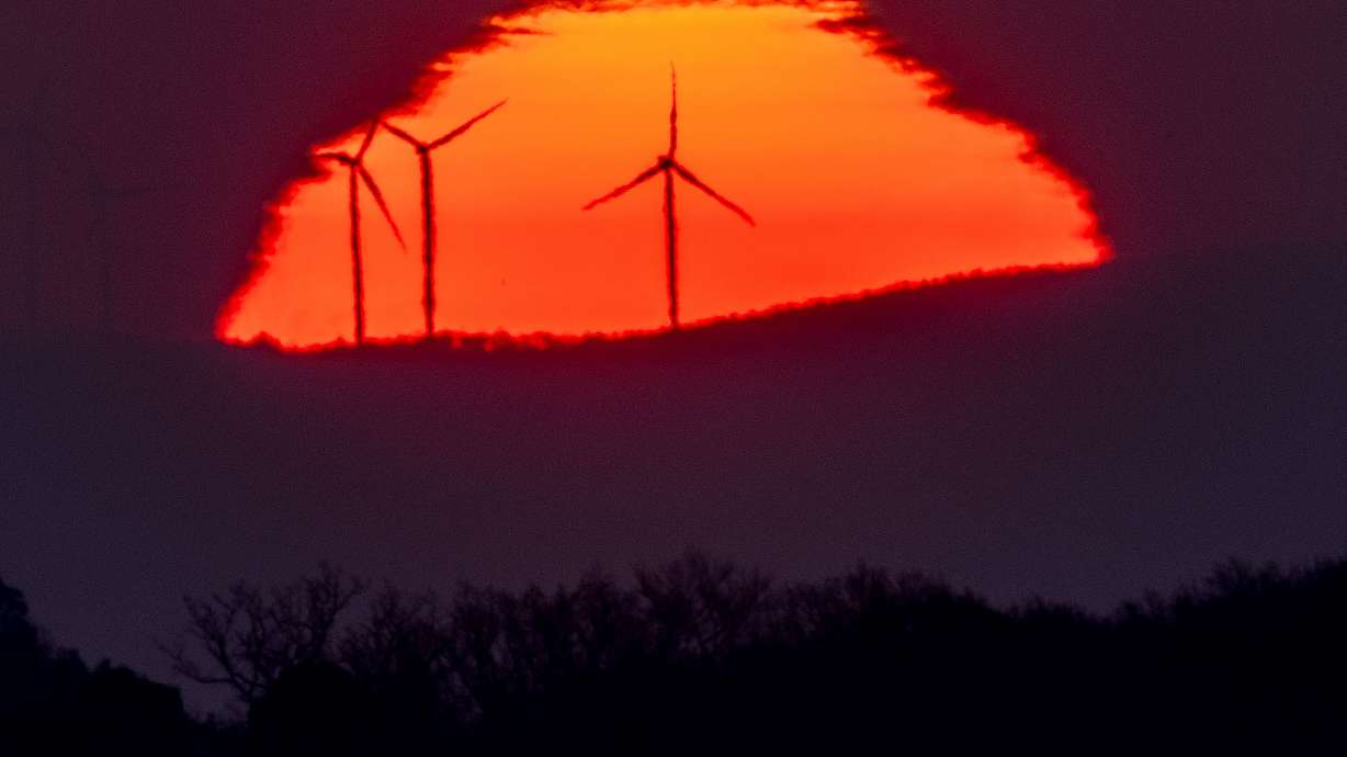 Wind turbines stand in front of the rising sun in Frankfurt, Germany, on Friday, March 11. The latest Intergovernmental Panel on Climate Change report warns that 2010-2019 average annual global greenhouse gas emissions were at their highest levels in human history and urgent action is needed.