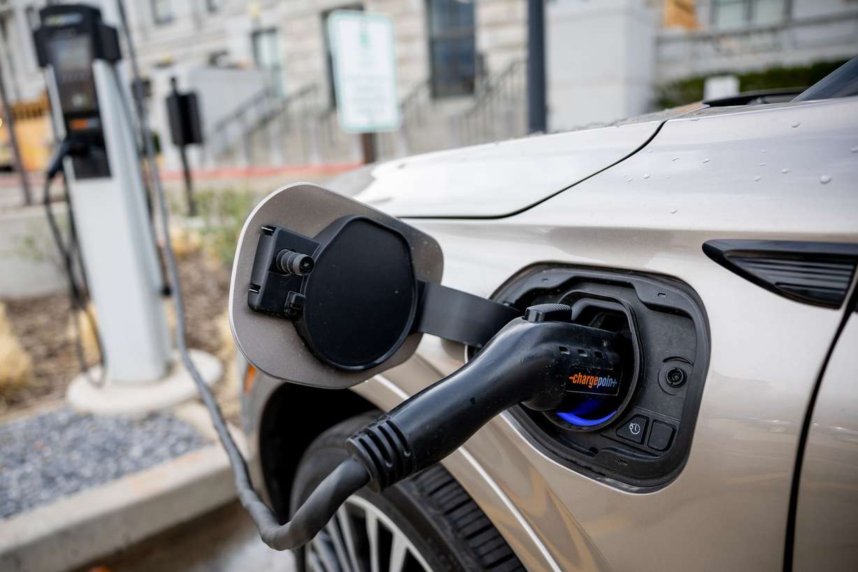 An electric vehicle charges at a charging station at the Capitol in Salt Lake City on Tuesday, March 29.