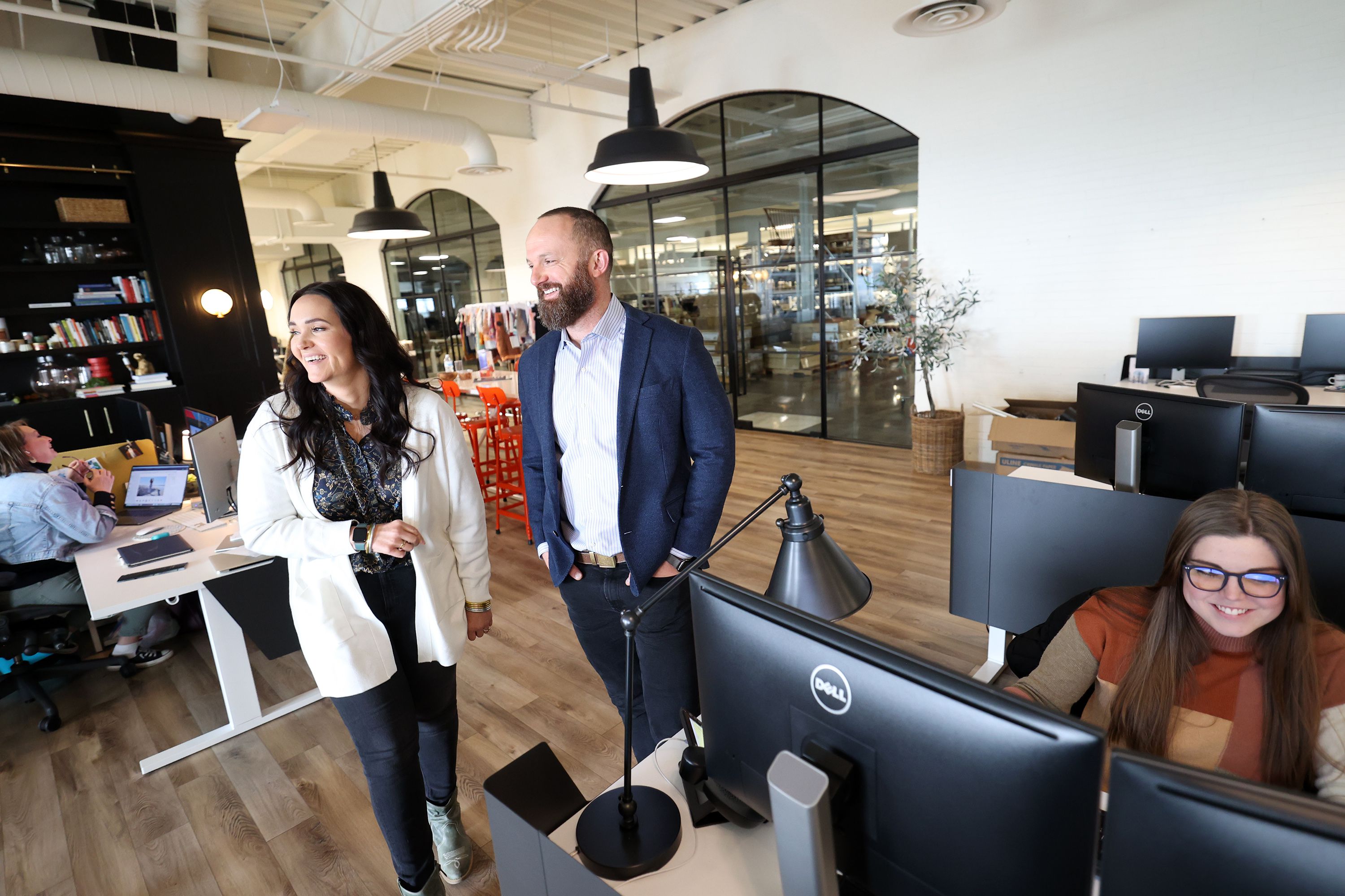 Sam and Kacie Malouf laugh and talk with employees in the area of their headquarters dedicated to the brand Downeast as they show the different sections of their business in Nibley, Cache County, on Tuesday, Jan. 18.