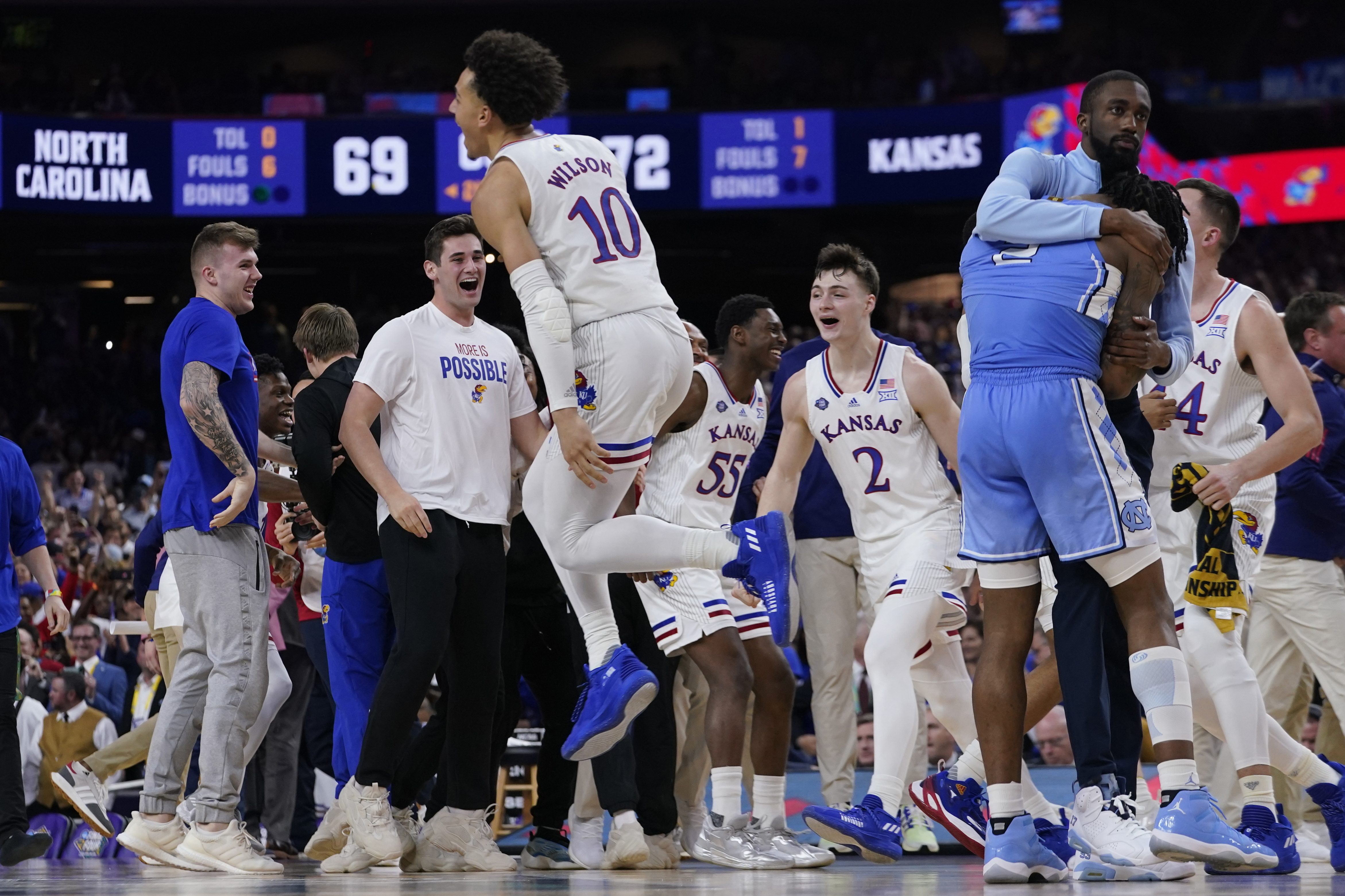 North Carolina guard Caleb Love, right, reacts to a loss as Kansas' Jalen Wilson (10) celebrates after a college basketball game in the finals of the Men's Final Four NCAA tournament, Monday, April 4, 2022, in New Orleans. Kansas won 72-69. 