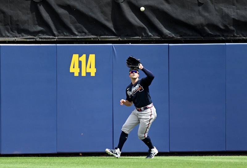 FILE PHOTO: Apr 4, 2022; Port Charlotte, Florida, USA;  Atlanta Braves center fielder Adam Duvall (14) catches a fly ball in the third inning against the Tampa Bay Rays during spring training at Charlotte Sports Park.