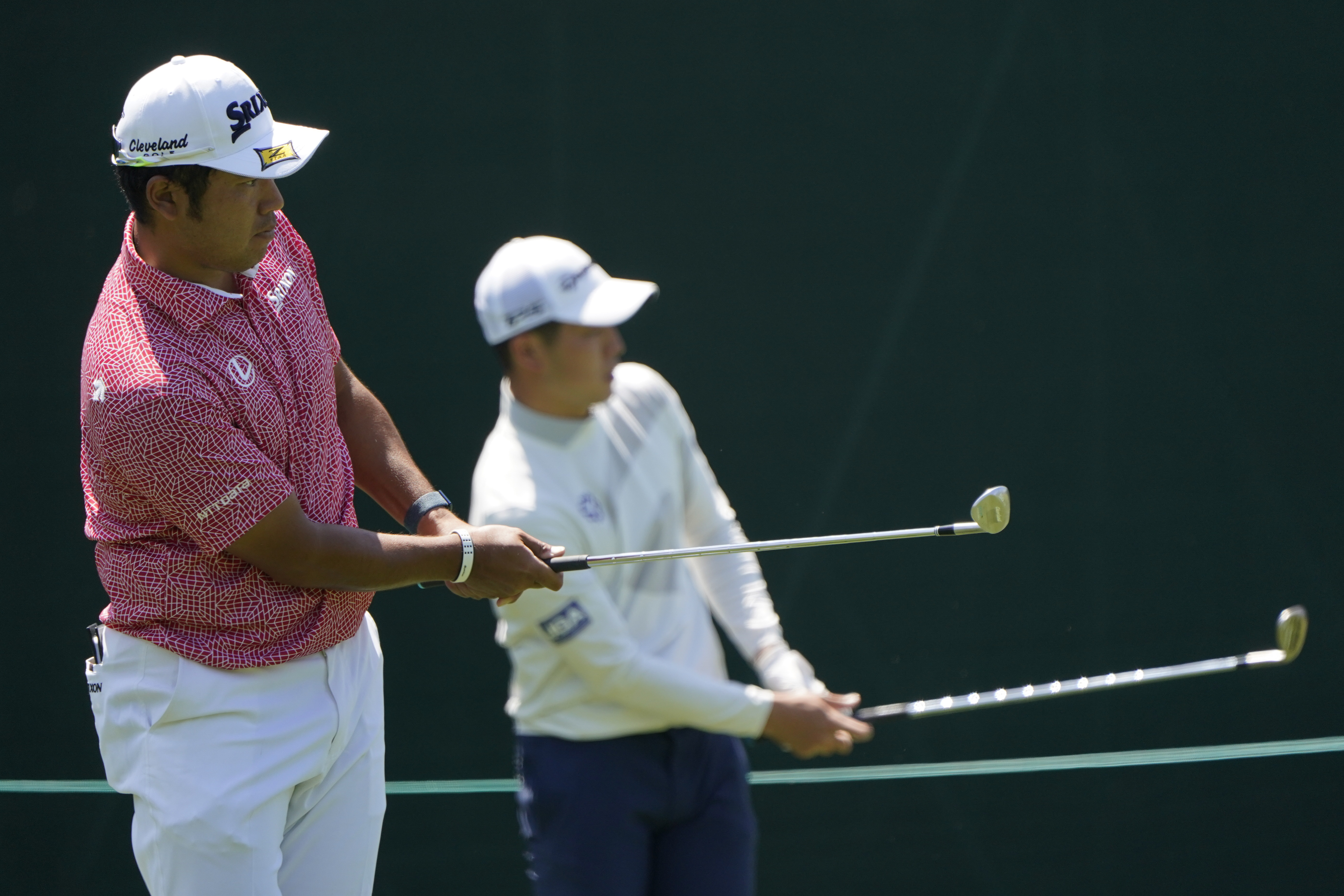 Hideki Matsuyama, of Japan, and Amateur Keita Nakajima, of Japan, hit shots on the 15th hole during a practice round for the Masters golf tournament on Monday, April 4, 2022, in Augusta, Ga. 