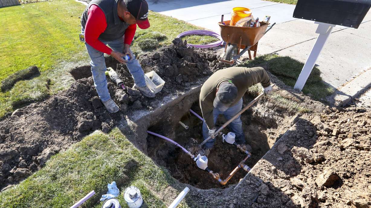 Ormond Construction crews install secondary water meters in a subdivision in Woods Cross for the Weber Basin Water Conservancy District on Nov. 7, 2019. Utah leaders opened up $250 million in grant funds this year to help chip away at Utah's massive backlog in secondary water meters.