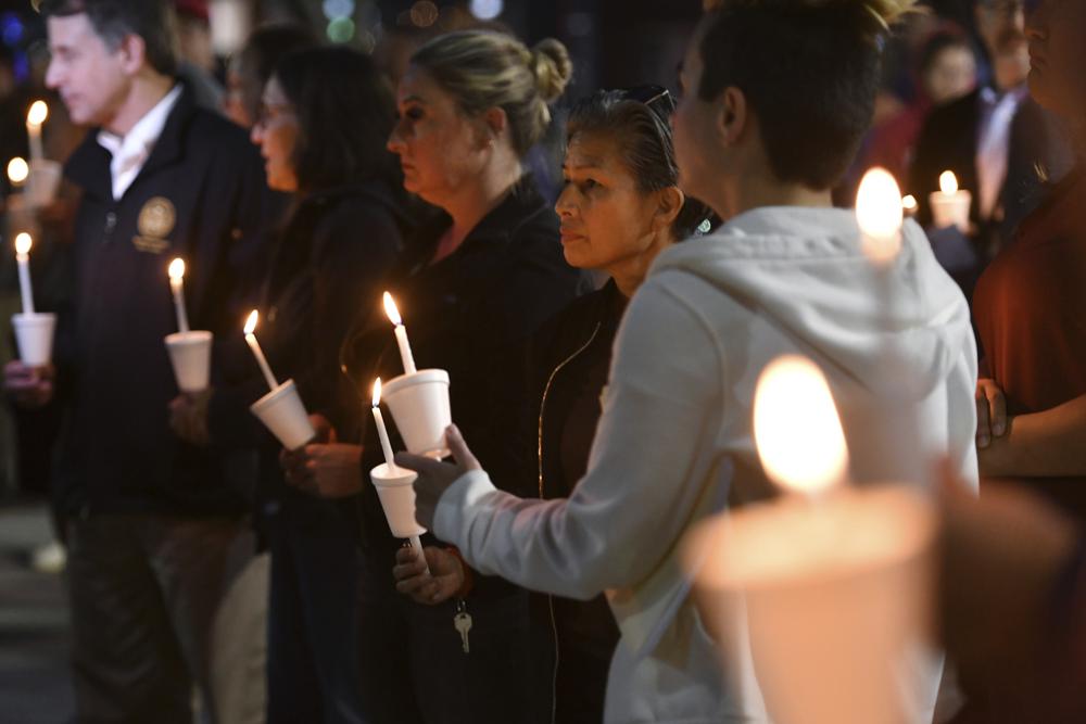 People attend a candlelight vigil for victims of a fatal shooting held at Ali Youssefi Square in Sacramento, Calif., late Monday. Multiple people were killed and injured after the shooting that occurred early Sunday. A second suspect has been arrested, authorities announced Tuesday.