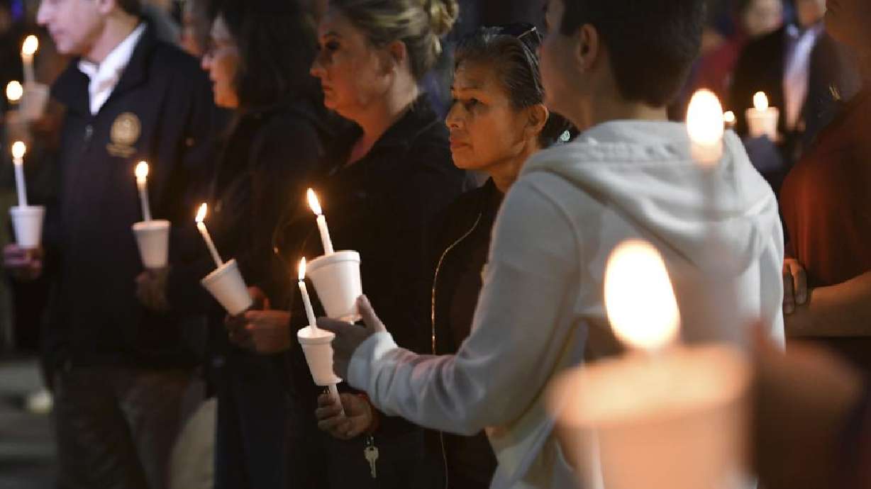 People attend a candlelight vigil for victims of a fatal shooting held at Ali Youssefi Square in Sacramento, Calif., late Monday. Multiple people were killed and injured after the shooting that occurred early Sunday. A second suspect has been arrested, authorities announced Tuesday.