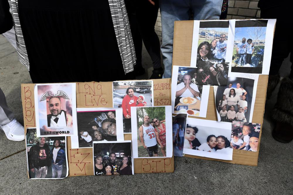 Photographs of De'vazia Turner are on display as his mother Penelope Scott speaks to the media during an interview at the corner of 10th and K street in Sacramento, Calif., on Monday. Turner was shot and killed after a shooting broke out early Sunday morning. Multiple people were killed and injured in the shooting.