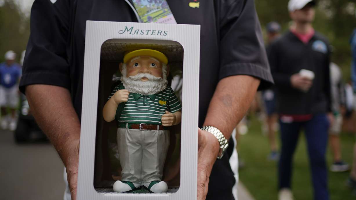 Dan Szatkowski, North Augusta, S.C, poses with his newly purchased garden gnome during a practice round for the Masters golf tournament on Tuesday, April 5, 2022, in Augusta, Ga.