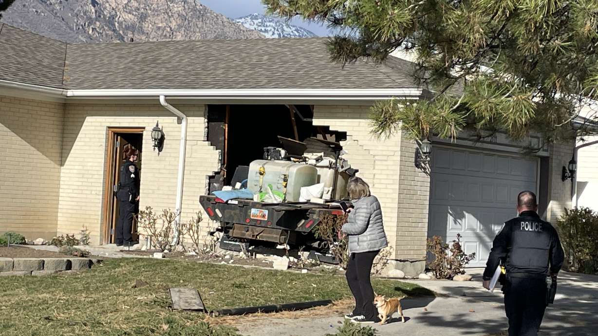 A truck crashed through the side of a house on the 2500 East block of Alta Canyon Drive in Sandy on Tuesday. Police say the crash happened when a driver who was watching YouTube on his cellphone missed a turn.