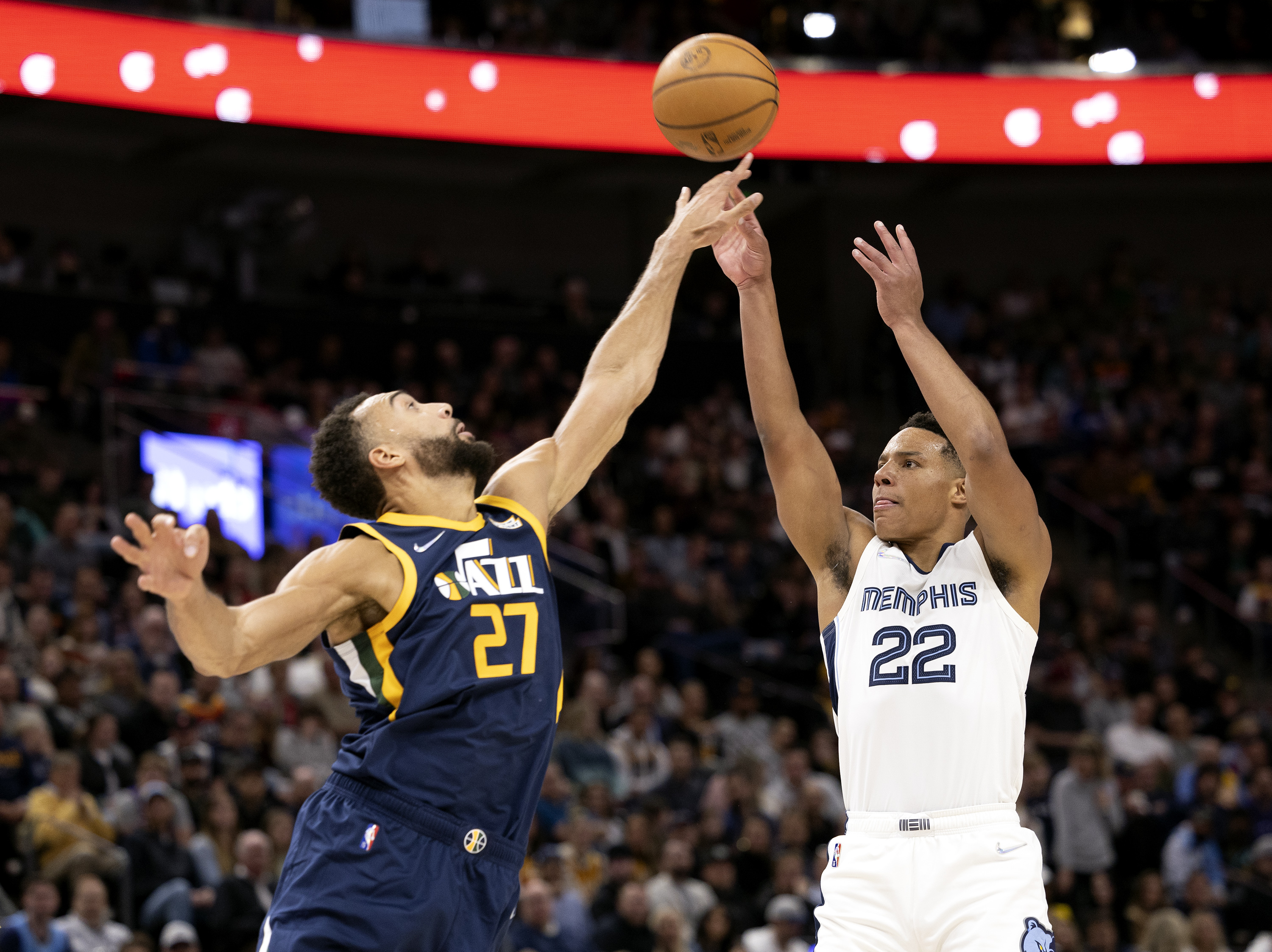 Utah Jazz center Rudy Gobert (27) stretches out as he defends a shot by Memphis Grizzlies guard Desmond Bane (22) as the Utah Jazz and the Memphis Grizzlies play an NBA basketball game at Vivint Arena in Salt Lake City on Tuesday, April 5, 2022.