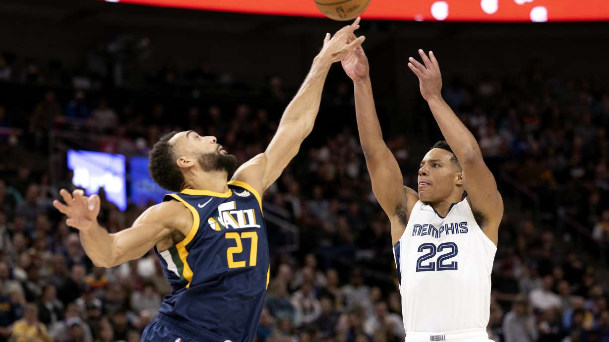 Utah Jazz center Rudy Gobert (27) stretches out as he defends a shot by Memphis Grizzlies guard Desmond Bane (22) as the Utah Jazz and the Memphis Grizzlies play an NBA basketball game at Vivint Arena in Salt Lake City on Tuesday, April 5, 2022.