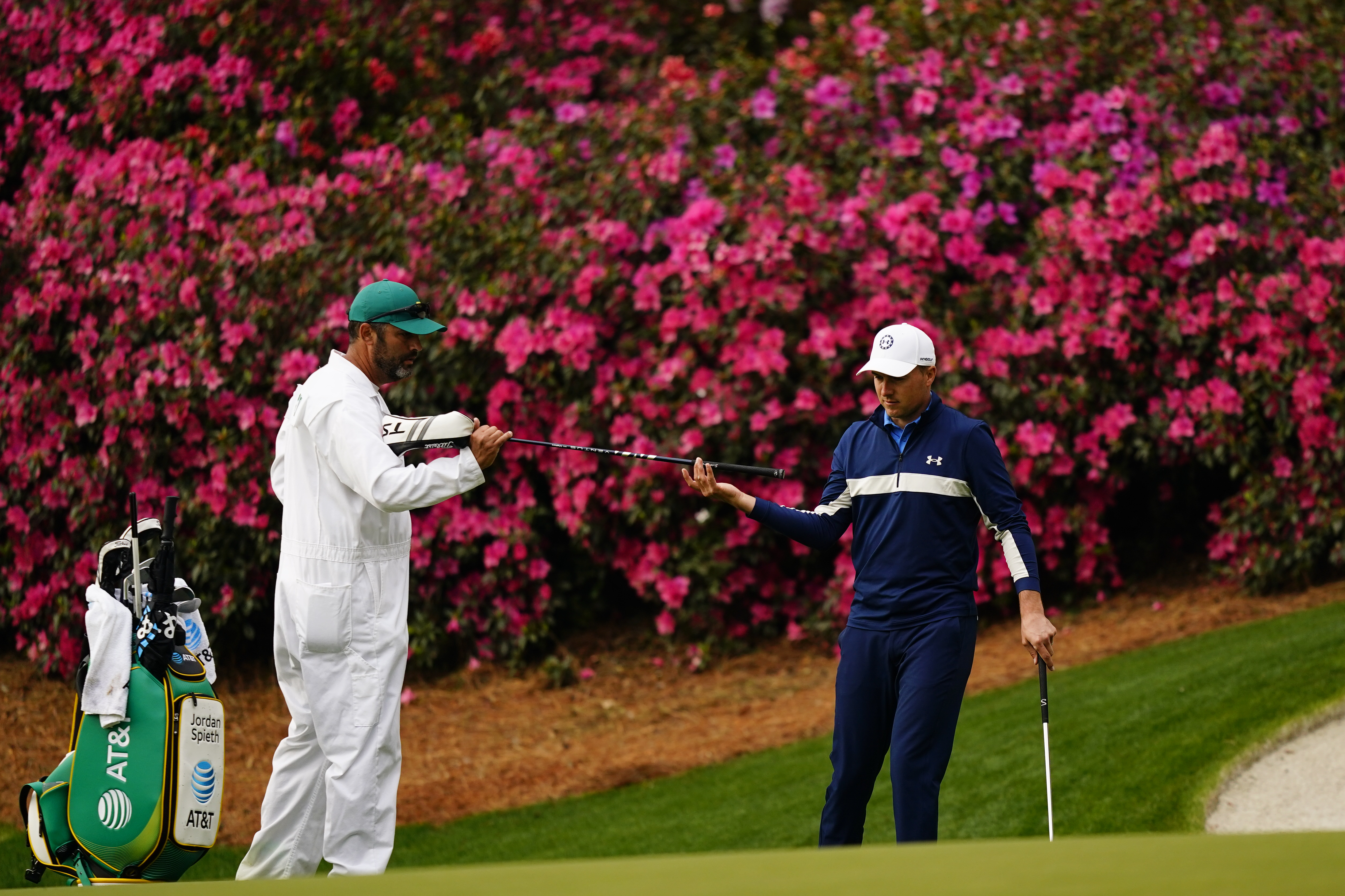 Jordan Spieth gets a club from his caddie on the 13th hole during a practice round for the Masters golf tournament on Tuesday, April 5, 2022, in Augusta, Ga. 