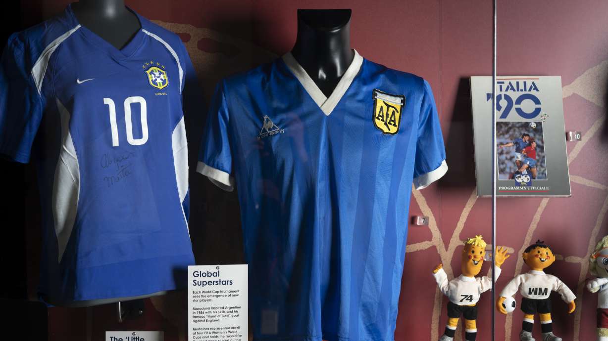 FILE - The soccer shirt, center, worn by Argentina's Diego Maradona in the 1986 World Cup quarterfinal against England is displayed at the National Football Museum in Manchester, England Nov. 26, 2020. The shirt worn by Diego Maradona when he scored the controversial “Hand of God” goal against England in the 1986 World Cup is for sale for the first time. Auctioneer Sotheby’s said Wednesday, April 6, 2022 that the jersey could fetch more than 4 million pounds ($5.2 million) in an online auction that opens April 20.
