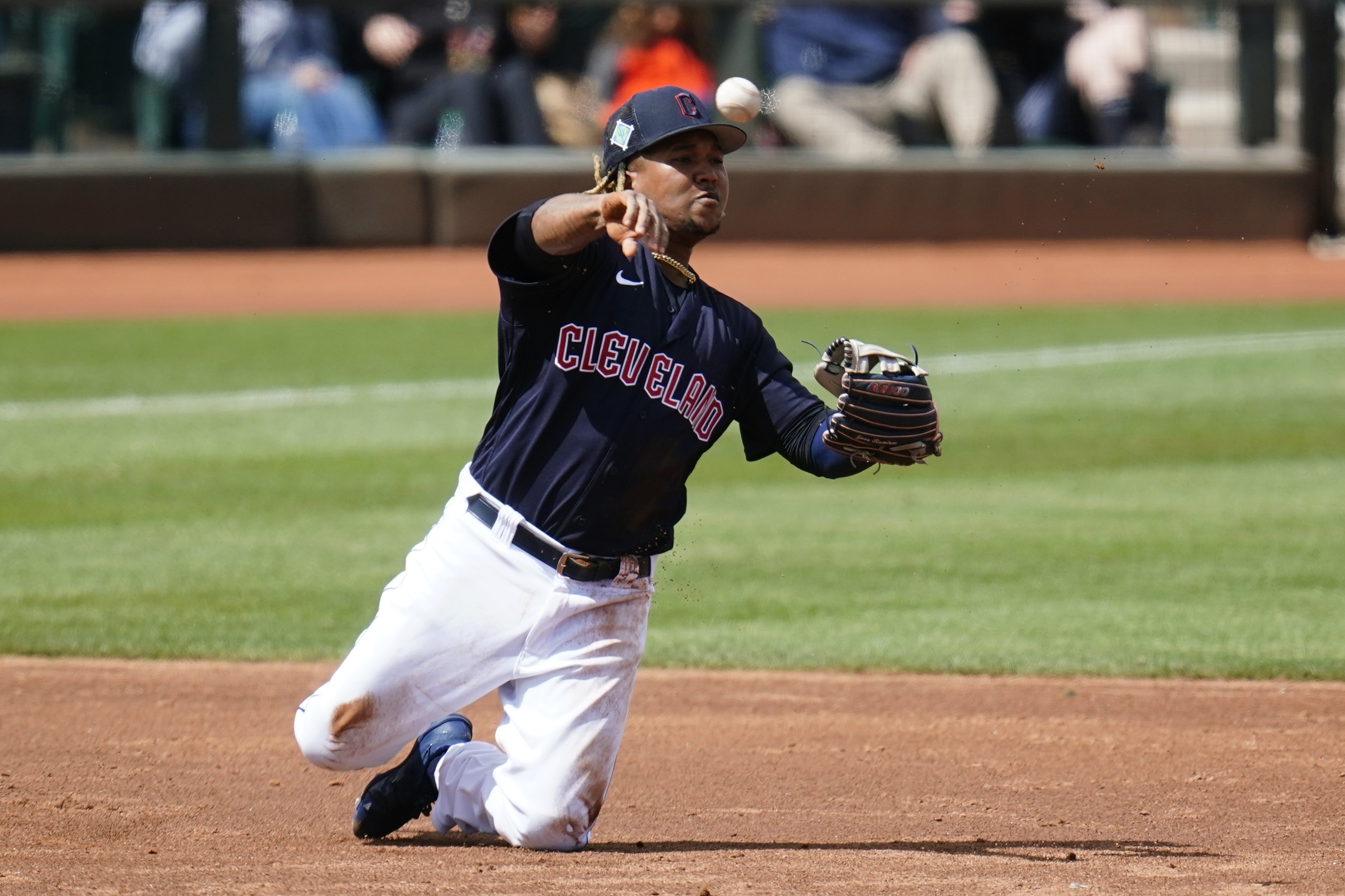 Cleveland Guardians third baseman Jose Ramirez throws from his knees to second base but is unable to get the force out on an infield single by Milwaukee Brewers' Pedro Severino during the third inning of a spring training baseball game Tuesday, March 29, 2022, in Goodyear, Ariz. 