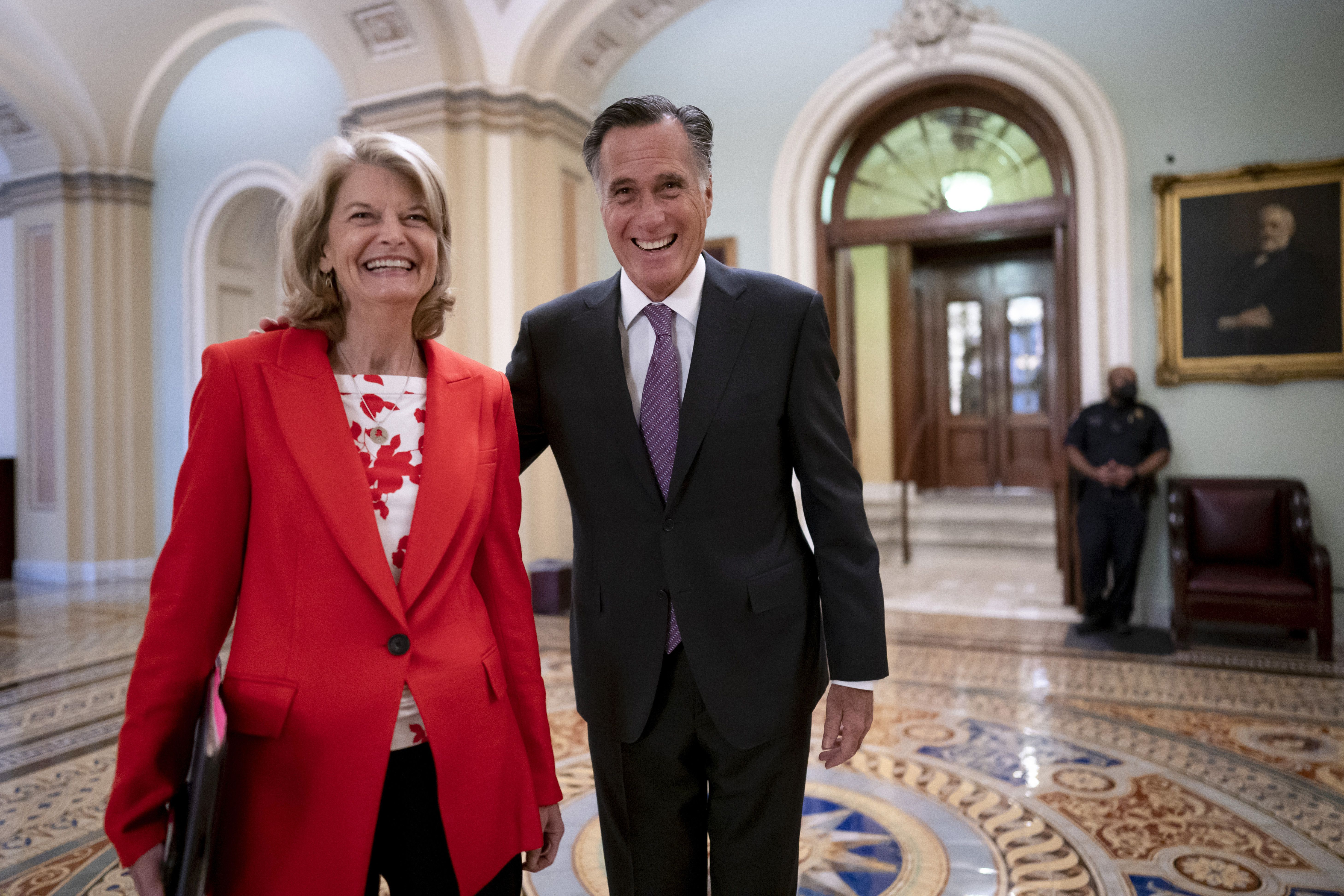Republican Senators Lisa Murkowski of Alaska, left, and Mitt Romney of Utah, who say they will vote to confirm Judge Ketanji Brown Jackson’s historic nomination to the Supreme Court, smile as they greet each other outside the chamber, at the Capitol in Washington, Tuesday.