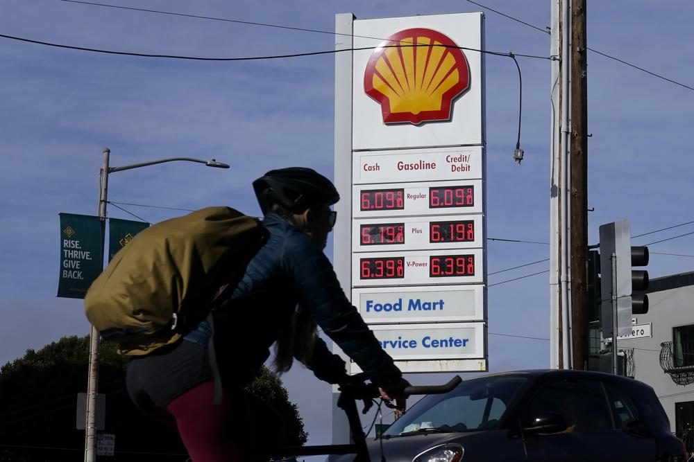 A bicyclist rides past a price board at a gas station in San Francisco, Monday. House Democrats on Wednesday accused oil companies of “ripping off the American people."