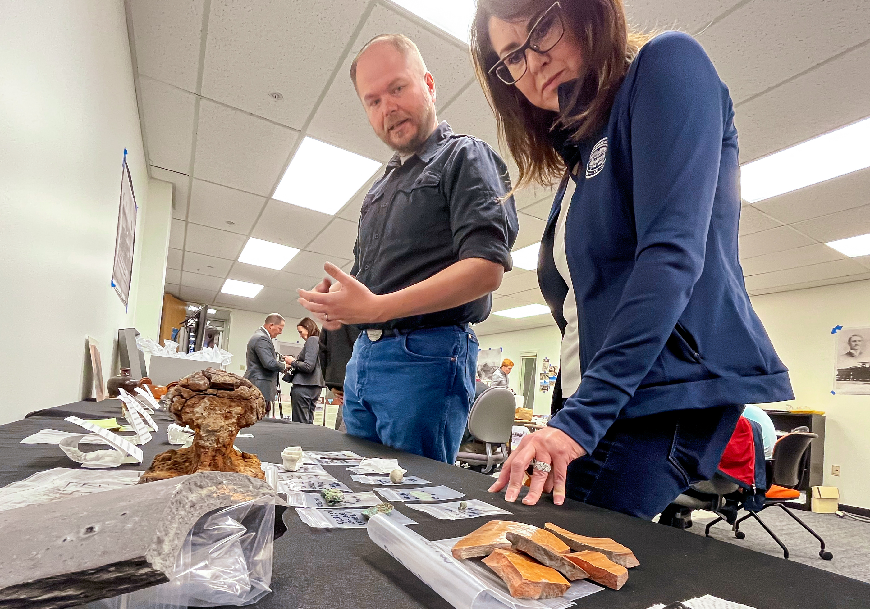 Chris Merritt, the preservation officer for the Utah Division of State History, left, provides information about artifacts collected from Terrace, Box Elder County, to Lt. Gov. Deidre Henderson Wednesday morning. Over 10,000 artifacts were uncovered in recent digs.