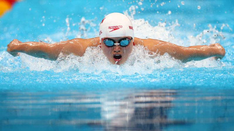 FILE PHOTO: Tokyo 2020 Olympics - Swimming - Women's 100m Butterfly - Heats - Tokyo Aquatics Centre - Tokyo, Japan - July 24, 2021. Maggie MacNeil of Canada in action