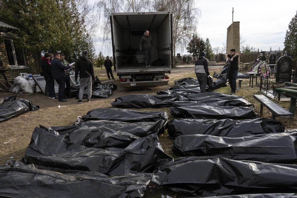 Cemetery workers load the corpses of civilians killed in Bucha into a truck, to be transported to the morgue, on the outskirts of Kyiv, Ukraine, Wednesday. The U.N. General Assembly voted Thursday to suspend Russia from the world organization’s leading human rights body over allegations of horrific rights violations by Russian soldiers in Ukraine