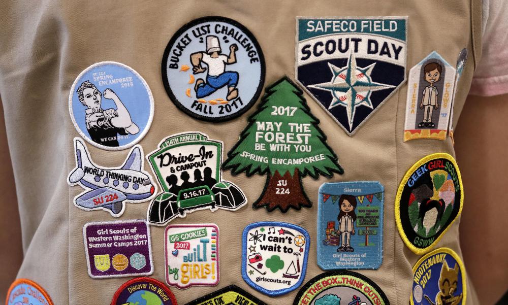Patches cover the back of a Girl Scout's vest at a demonstration of some of their activities in Seattle, June 18, 2018. A federal judge, Thursday tossed out a lawsuit in which the Girl Scouts claim that the Boy Scouts are creating marketplace confusion and damaging their recruitment efforts through their use of words such as "Scouts" and "Scouting."