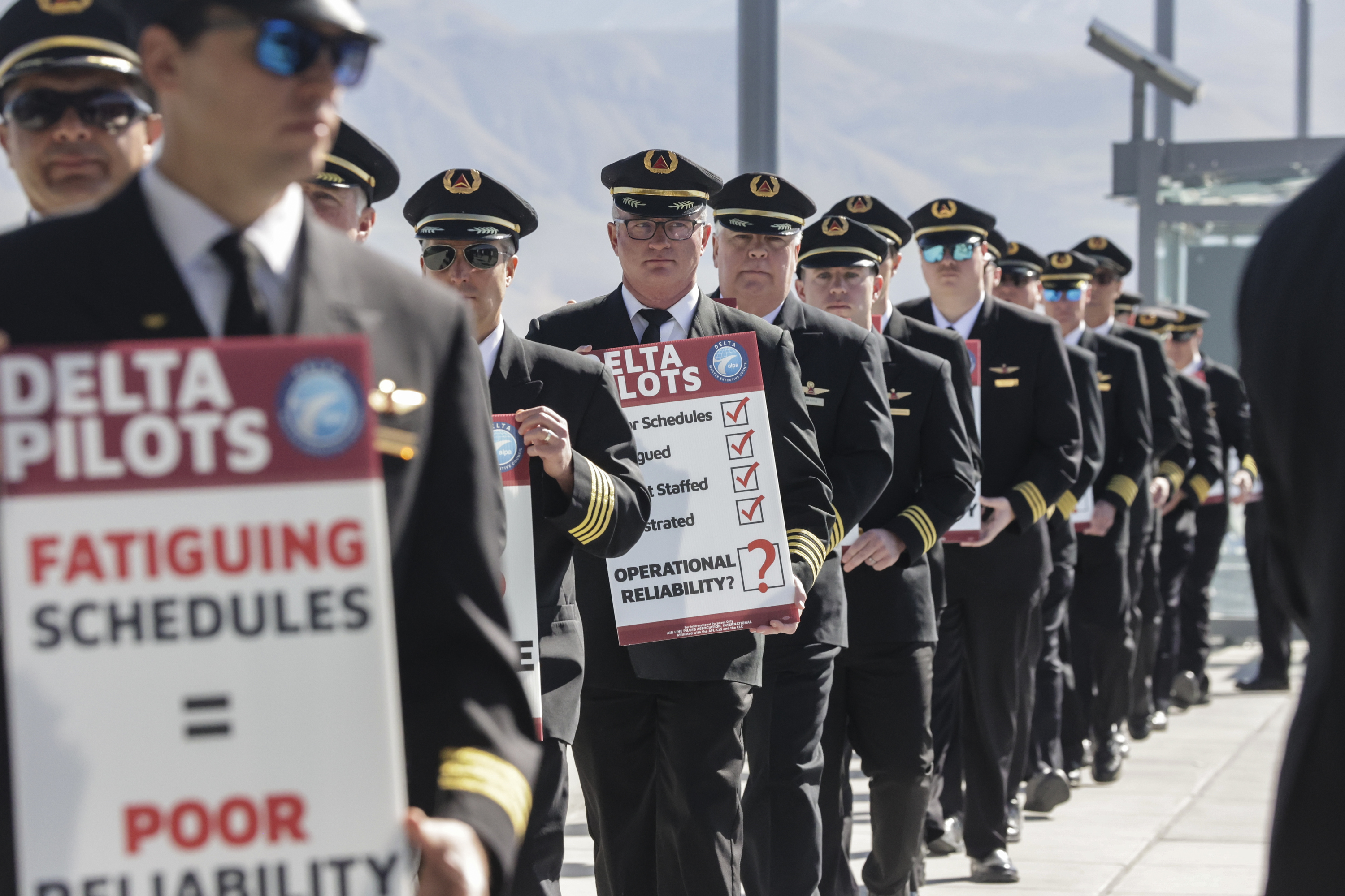 Delta pilots picket at Salt Lake City International Airport in Salt Lake City on Thursday. The pilots are protesting Delta management’s scheduling practices, which they say have caused pilots to fly long and often fatiguing trips.