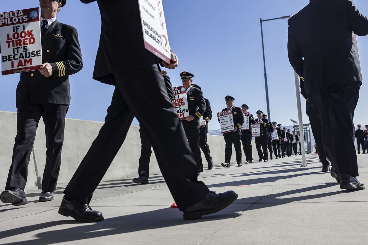 Delta pilots sit at Salt Lake City International Airport in Salt Lake City on Thursday. Pilots are protesting Delta's scheduling practices, which they say have caused pilots to take long and often stressful flights.