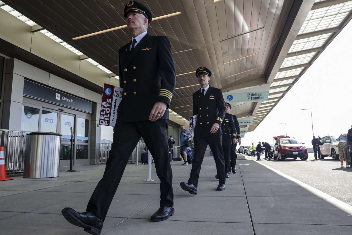 Delta pilots sit at Salt Lake City International Airport in Salt Lake City on Thursday. Pilots are protesting Delta's scheduling practices, which they say have caused pilots to take long and often stressful flights.