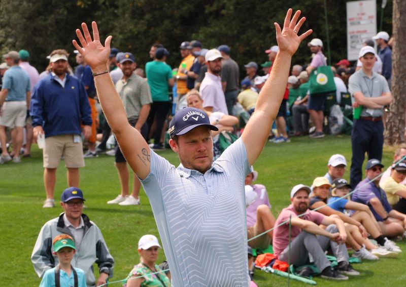 Golf - The Masters - Augusta National Golf Club - Augusta, Georgia, U.S. - April 6, 2022 England's Danny Willett reacts to England's Lee Westwood second shot on the 2nd during the par 3 tournament