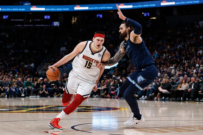 Apr 7, 2022; Denver, Colorado, USA; Denver Nuggets center Nikola Jokic (15) drives to the net against Memphis Grizzlies center Steven Adams (4) in the third quarter at Ball Arena.