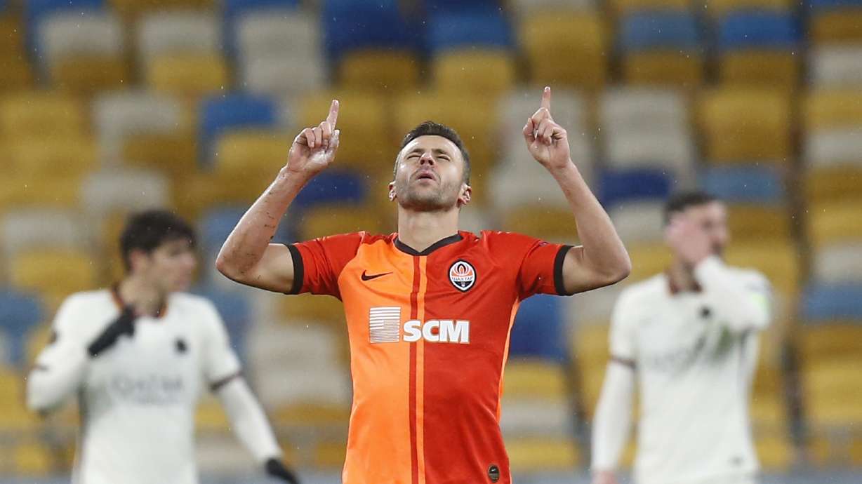 FILE - Shakhtar's Junior Moraes celebrates after scoring his side's opening goal during the Europa League round of 16 second leg soccer match between Shakhtar Donetsk and Roma at the Olimpiyskiy Stadium in Kyiv, Ukraine, on March 18, 2021. Veteran striker Junior Moraes has returned to Brazil to join Corinthians, but on Tuesday he admitted his mind far from sport. The 34-year-old Moraes, who obtained Ukrainian citizenship three years ago, fears for his friends, colleagues and teammates amid Russia's invasion of the European country.