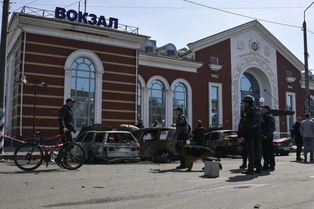 Ukrainian servicemen stand next to damaged cars after Russian shelling at the railway station in Kramatorsk, Ukraine, Friday. Hours after warning that Ukraine's forces already had found worse scenes of brutality in a settlement north of Kyiv, President Volodymyr Zelenskyy said that “thousands” of people were at the station in Kramatorsk, a city in the eastern Donetsk region, when it was hit by a missile.