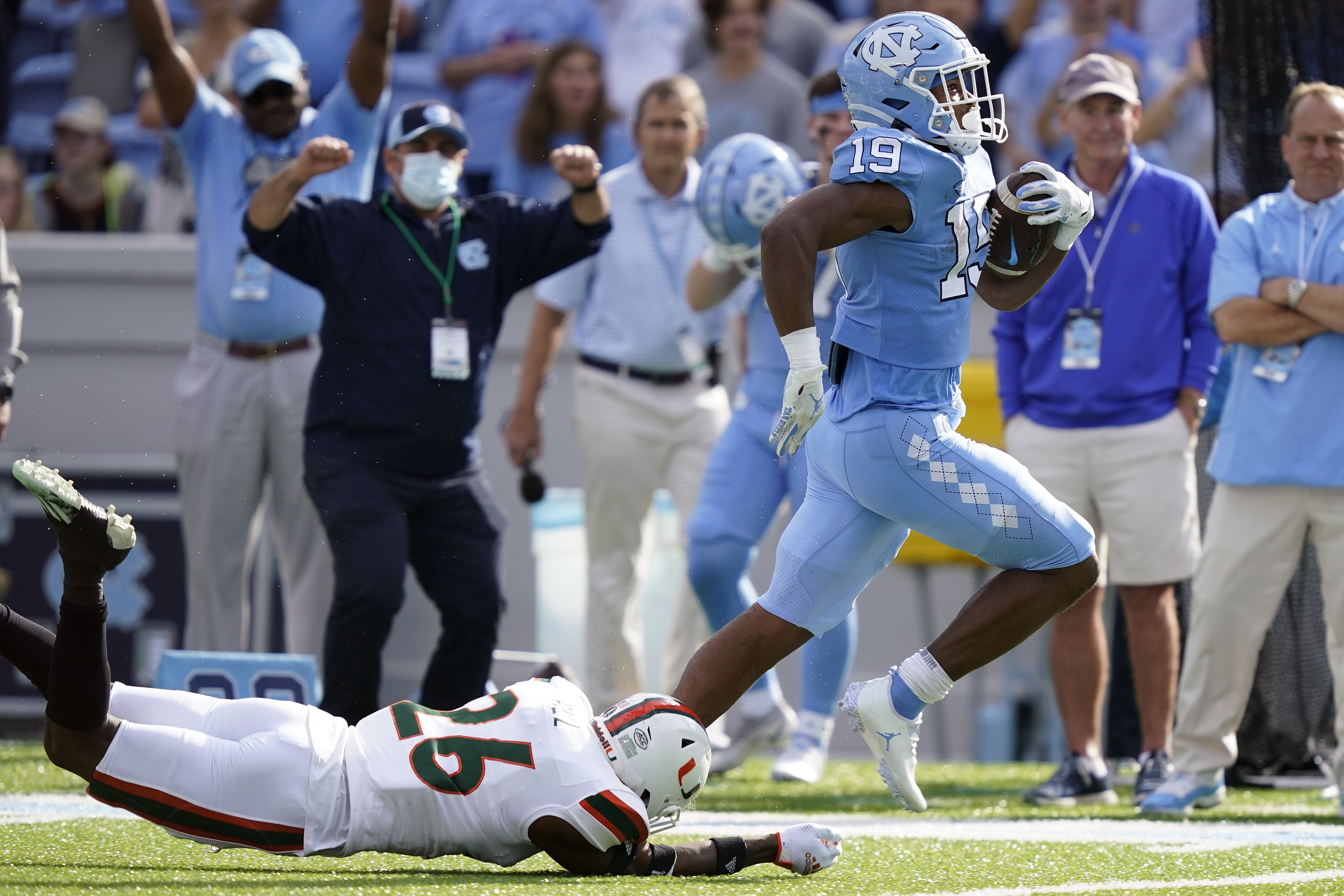 North Carolina running back Ty Chandler (19) runs for a touchdown while Miami safety Gurvan Hall Jr. (26) misses the tackle during the first half of an NCAA college football game in Chapel Hill, N.C., Saturday, Oct. 16, 2021.