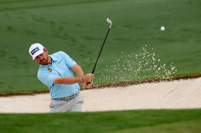 FILE PHOTO: Golf - The Masters - Augusta National Golf Club - Augusta, Georgia, U.S. - April 6, 2022 South Africa's Louis Oosthuizen plays out from the bunker on the 2nd during a practice round