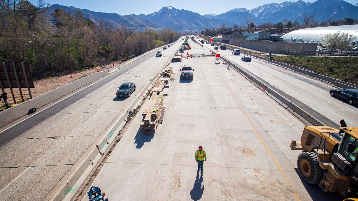 Construction crews get into place Friday as they prepare to demolish a bridge on 1700 East over I-80 in Salt Lake City. They will immediately replace the old bridge with a new one, but the project will close I-80 in both directions Friday night into Sunday afternoon.
