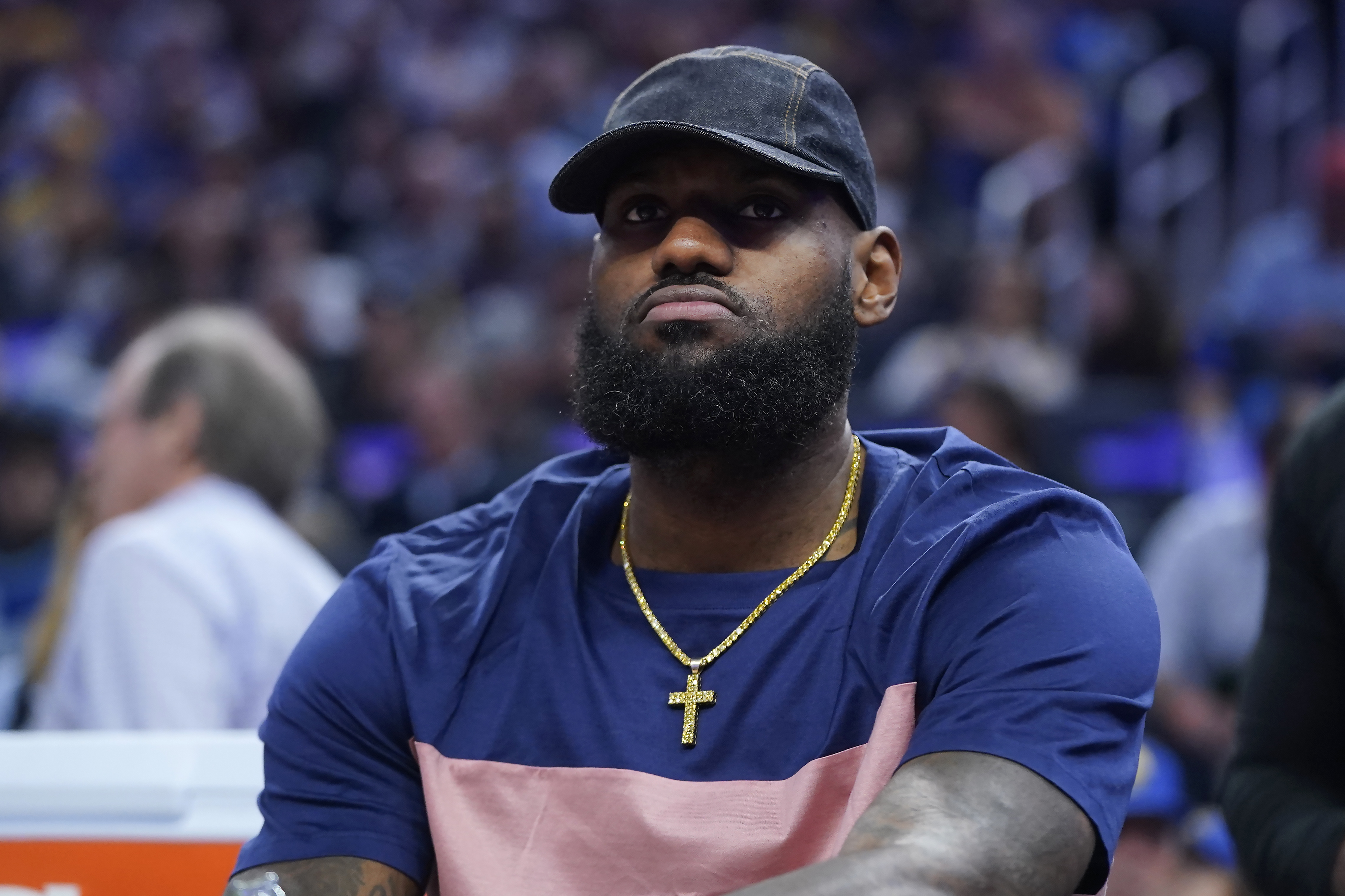 Los Angeles Lakers' LeBron James sits on the bench during the first half of the team's NBA basketball game against the Golden State Warriors in San Francisco, Thursday, April 7, 2022. 