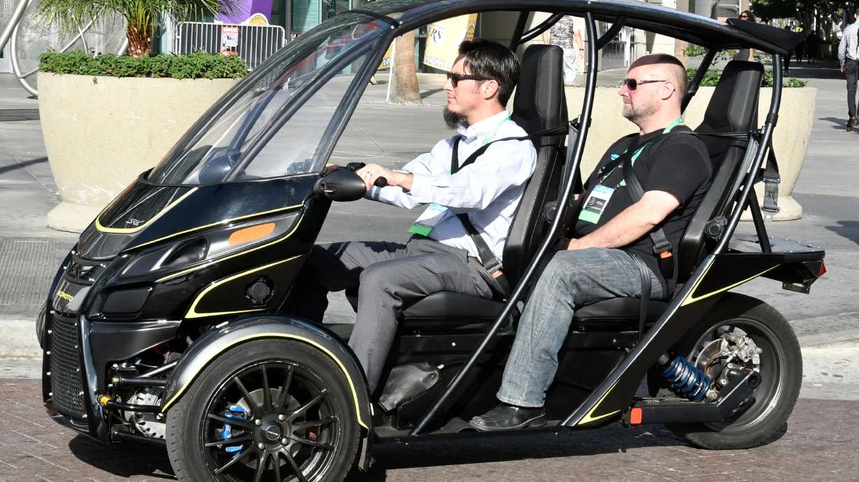 Arcimoto Sris 3 wheel gives test drives during the 2017 LA Auto show media day, Nov. 29, 2017. A new Utah law allows for drivers to ride all autocycles with a class D permit, regardless of what their steering device looks like.
