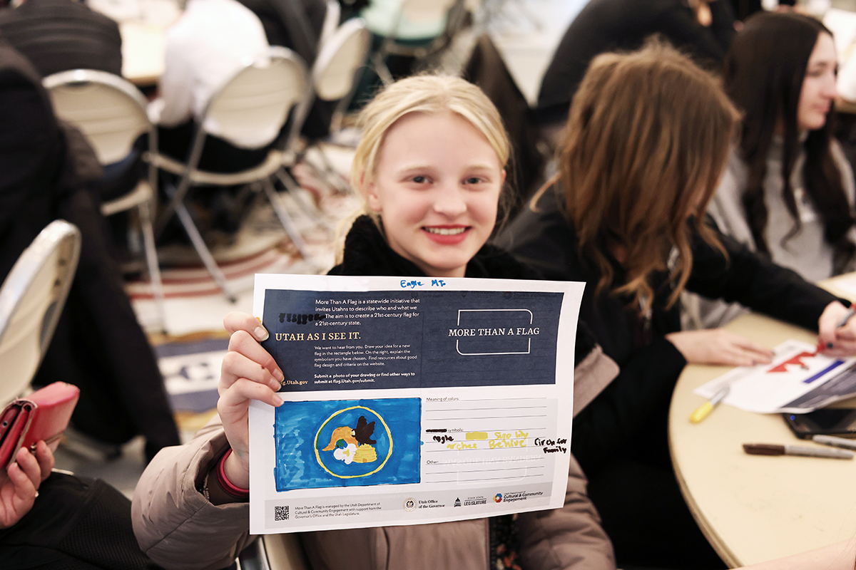 Student displays her flag design at a Utah League of Cities and Towns workshop. (Photo: Todd Anderson)