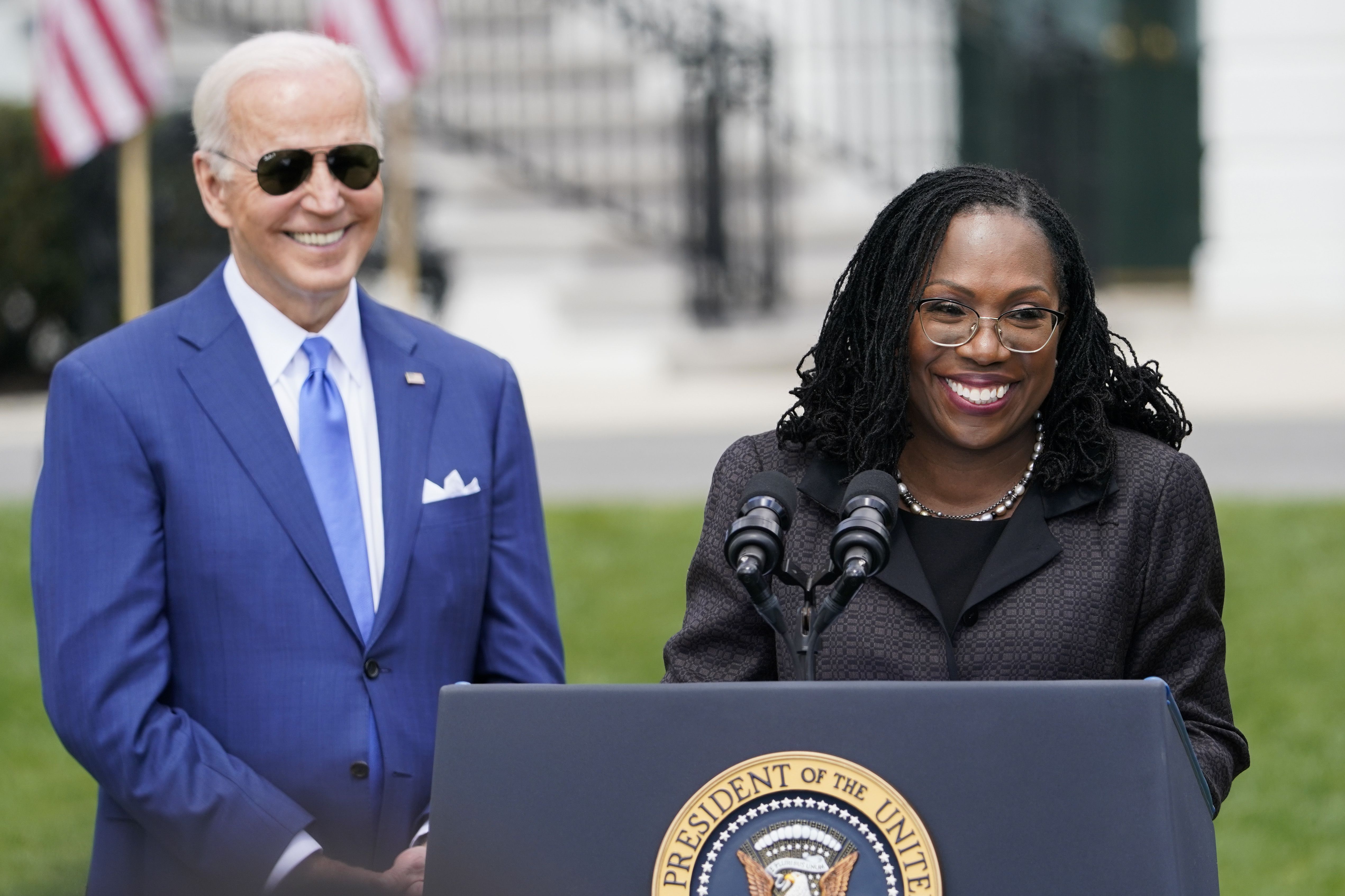 President Joe Biden listens as Judge Ketanji Brown Jackson speaks during an event on the South Lawn of the White House in Washington, Friday, celebrating the confirmation of Jackson as the first Black woman to be named to the Supreme Court.