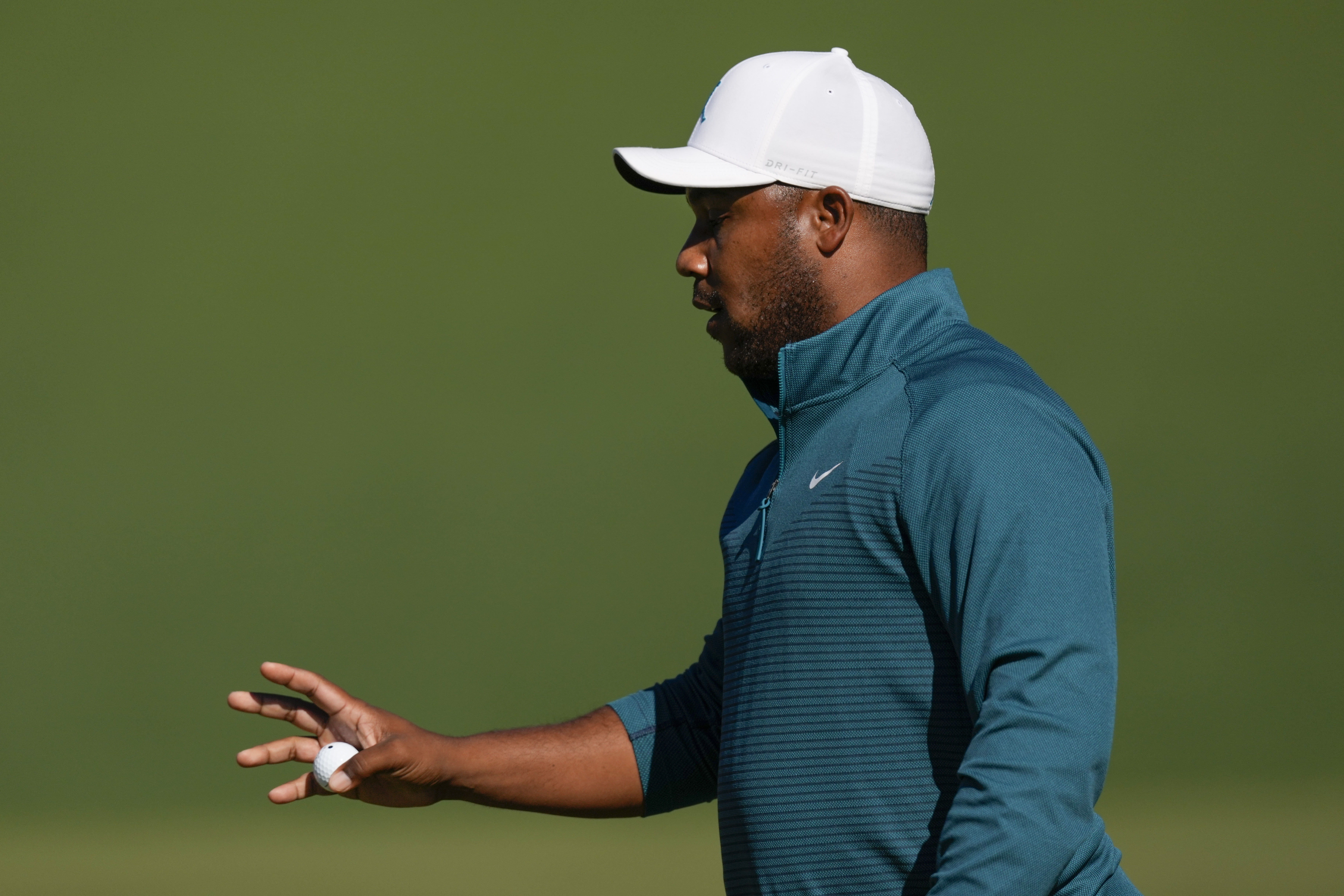Harold Varner III holds up his ball after a birdie on the second hole during the second round at the Masters golf tournament on Friday, April 8, 2022, in Augusta, Ga. 
