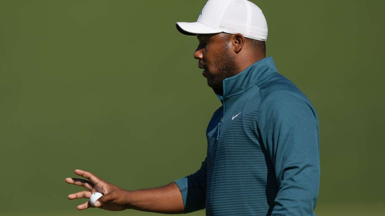 Harold Varner III holds up his ball after a birdie on the second hole during the second round at the Masters golf tournament on Friday, April 8, 2022, in Augusta, Ga.